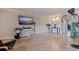Open living room featuring a TV, tile flooring, light walls, and lots of natural light at 2525 W Bay Dr # B43, Belleair Bluffs, FL 33770