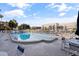 Swimming pool with several chair and table seating arrangements and building in the background at 2525 W Bay Dr # B43, Belleair Bluffs, FL 33770
