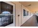 Exterior walkway featuring unit entrances, neutral tones, and an open-air design with an iron railing at 2525 W Bay Dr # B43, Belleair Bluffs, FL 33770