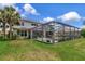 The spacious backyard features an in-ground, screened-in pool and lush green landscaping at 26972 Evergreen Chase Dr, Wesley Chapel, FL 33544
