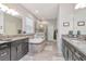 Bright bathroom featuring a soaking tub with a shower and dual sinks with granite countertops at 26972 Evergreen Chase Dr, Wesley Chapel, FL 33544