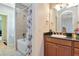 Bathroom features a tub with a shower, a sink with dark granite countertops, and vanity at 26972 Evergreen Chase Dr, Wesley Chapel, FL 33544