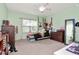 Bright bedroom featuring a ceiling fan and a sunny window with natural lighting at 26972 Evergreen Chase Dr, Wesley Chapel, FL 33544
