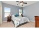 A light blue bedroom featuring a queen bed and windows with wood blinds at 26972 Evergreen Chase Dr, Wesley Chapel, FL 33544