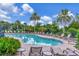 Enjoy the community pool with plenty of seating and lush tropical landscaping at 26972 Evergreen Chase Dr, Wesley Chapel, FL 33544
