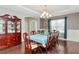 Traditional dining room with hardwood floors, wainscotting, a chandelier, and a large table at 26972 Evergreen Chase Dr, Wesley Chapel, FL 33544