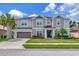 Two story home featuring neat landscaping, a two car garage, and neutral toned paint at 26972 Evergreen Chase Dr, Wesley Chapel, FL 33544