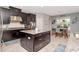 Modern kitchen with dark cabinets, granite countertops, stainless steel appliances, and a center island at 26972 Evergreen Chase Dr, Wesley Chapel, FL 33544