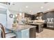 Modern kitchen featuring dark cabinets, granite countertops, stainless steel appliances, and pendant lighting above a center island at 26972 Evergreen Chase Dr, Wesley Chapel, FL 33544