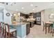Spacious kitchen boasts dark cabinets, granite countertops, stainless steel appliances, and a large island with bar seating at 26972 Evergreen Chase Dr, Wesley Chapel, FL 33544