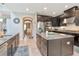Spacious kitchen with dark cabinets, granite countertops, stainless steel appliances, and a view into adjacent dining area at 26972 Evergreen Chase Dr, Wesley Chapel, FL 33544