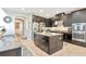 Well-appointed kitchen with dark wood cabinets, granite countertops, stainless steel appliances, and a center island with storage at 26972 Evergreen Chase Dr, Wesley Chapel, FL 33544
