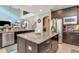 Open kitchen features dark cabinets, stainless steel appliances, granite countertops, and a center island at 26972 Evergreen Chase Dr, Wesley Chapel, FL 33544