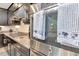 Close-up of modern stainless steel double ovens with decorative towels hanging from the handles, next to gas cooktop at 26972 Evergreen Chase Dr, Wesley Chapel, FL 33544