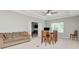 This upstairs living area has comfortable seating and a dining table at 26972 Evergreen Chase Dr, Wesley Chapel, FL 33544