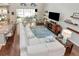A spacious living room is equipped with a large white couch and overlooks a patio area at 26972 Evergreen Chase Dr, Wesley Chapel, FL 33544