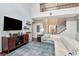 Cozy living room featuring an entertainment center, comfortable seating, and a view of the foyer at 26972 Evergreen Chase Dr, Wesley Chapel, FL 33544