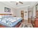 Relaxing main bedroom boasts wood floors, ceiling fan, and a private en suite bathroom at 26972 Evergreen Chase Dr, Wesley Chapel, FL 33544