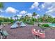 Community playground featuring slides, benches, and rideable firetruck and dragon spring toys at 26972 Evergreen Chase Dr, Wesley Chapel, FL 33544