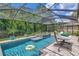 Screened-in pool and jacuzzi, with a hammock for relaxation at 26972 Evergreen Chase Dr, Wesley Chapel, FL 33544