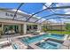 The large, screened-in in-ground pool, jacuzzi and outdoor kitchen are great for relaxing at 26972 Evergreen Chase Dr, Wesley Chapel, FL 33544