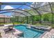 Screened-in pool and spa area with ample lounging space surrounded by lush landscaping at 26972 Evergreen Chase Dr, Wesley Chapel, FL 33544