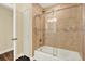 Bathroom with sliding glass door shower, decorative showerhead, and neutral tile at 2806 Fairway View Dr, Valrico, FL 33596