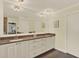 Bathroom featuring double sinks, granite counters, neutral paint and a large mirror at 2806 Fairway View Dr, Valrico, FL 33596