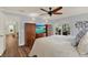 Bedroom with wood floors, a ceiling fan, and direct access to screened-in patio at 2806 Fairway View Dr, Valrico, FL 33596