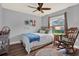 Bedroom with a rocking chair, ceiling fan, wood flooring, and bright window at 2806 Fairway View Dr, Valrico, FL 33596