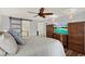Bedroom with wood floors, a ceiling fan, and custom built in armoires and dressers at 2806 Fairway View Dr, Valrico, FL 33596