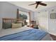 Bedroom with wood flooring, a ceiling fan, and bright window at 2806 Fairway View Dr, Valrico, FL 33596
