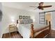 Bedroom features a wood accent wall, ceiling fan, and sliding barn door to the en-suite bathroom at 2806 Fairway View Dr, Valrico, FL 33596