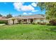 Well-maintained single-story home with lush lawn, mature trees, and decorative landscaping enhancing its curb appeal at 2806 Fairway View Dr, Valrico, FL 33596
