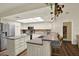 Bright kitchen features white cabinets, stainless steel appliances, a breakfast bar, and wood flooring at 2806 Fairway View Dr, Valrico, FL 33596