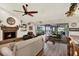 Spacious living room boasts hardwood floors, a stone fireplace, and seamless access to an enclosed patio at 2806 Fairway View Dr, Valrico, FL 33596