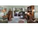 Comfortable living room with hardwood floors, patio access, and an adjacent work area featuring desk and storage at 2806 Fairway View Dr, Valrico, FL 33596