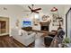 Living room includes a stone fireplace, hardwood floors, comfortable seating, and a television at 2806 Fairway View Dr, Valrico, FL 33596