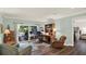 Bright living room with access to a patio, wood floors, and an adjacent work area and bedroom space at 2806 Fairway View Dr, Valrico, FL 33596