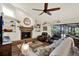 Bright living room features hardwood floors, a stone fireplace, and access to the enclosed patio at 2806 Fairway View Dr, Valrico, FL 33596