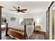 Elegant main bedroom featuring hardwood floors, shiplap accent wall, and modern ceiling fan and access to main bathroom at 2806 Fairway View Dr, Valrico, FL 33596