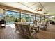 Relaxing screened patio with brick floor, ceiling fans, and poolside seating at 2806 Fairway View Dr, Valrico, FL 33596
