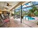 Screened lanai with a pool, hot tub, waterfalls, and outdoor seating at 2806 Fairway View Dr, Valrico, FL 33596