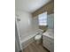 Clean bathroom featuring a shower-tub combo and white tiled walls at 3007 Wainwright Ct, New Port Richey, FL 34655
