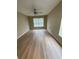 A sunny room featuring a ceiling fan and new wood-look flooring at 3007 Wainwright Ct, New Port Richey, FL 34655