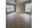 Bright bedroom featuring two windows for abundant natural light, and modern flooring at 3007 Wainwright Ct, New Port Richey, FL 34655