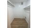 Walk-in closet with ample space for clothing and accessories, plus modern flooring at 3007 Wainwright Ct, New Port Richey, FL 34655