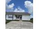 Charming single-story villa with a white exterior, red shutters, and a well-maintained front yard at 3007 Wainwright Ct, New Port Richey, FL 34655