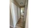 Hallway view with neutral walls, base trim, and doorways leading to a bathroom and bedroom at 3007 Wainwright Ct, New Port Richey, FL 34655