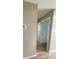Hallway with neutral walls and trim, showcasing modern flooring and convenient access to other rooms at 3007 Wainwright Ct, New Port Richey, FL 34655